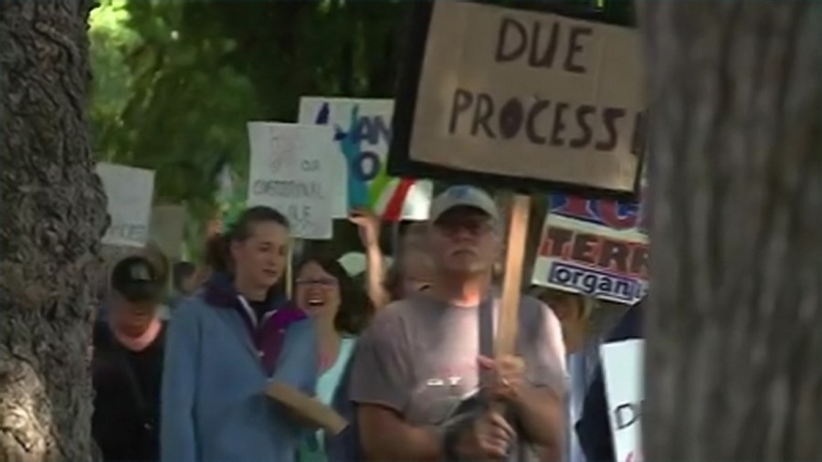 Rallygoers protest against ‘appalling' ICE arrest of asylum seeker