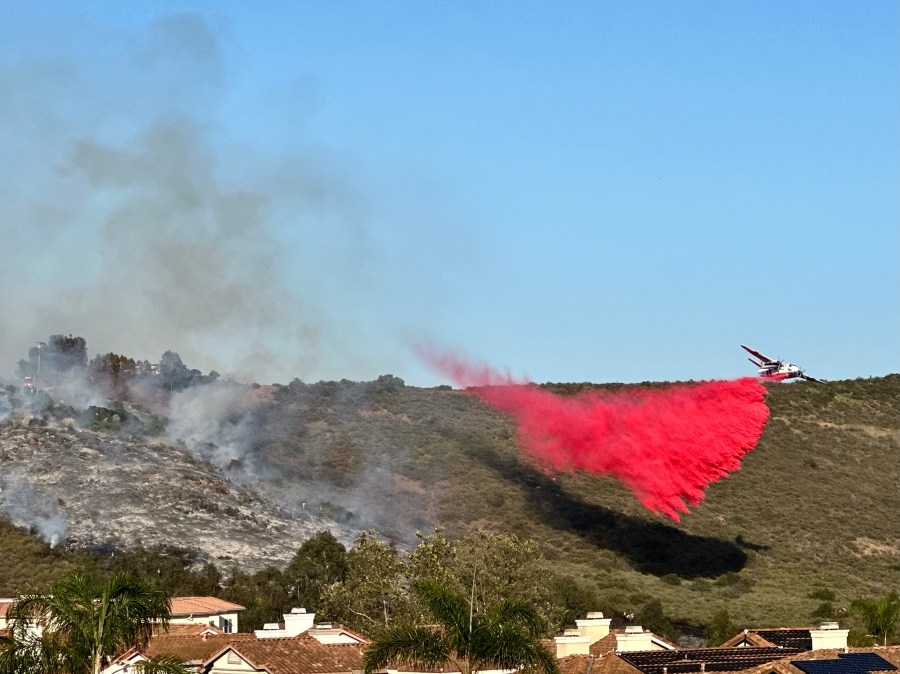 PHOTOS: Plane drops red retardant over Springhurst Fire in North County