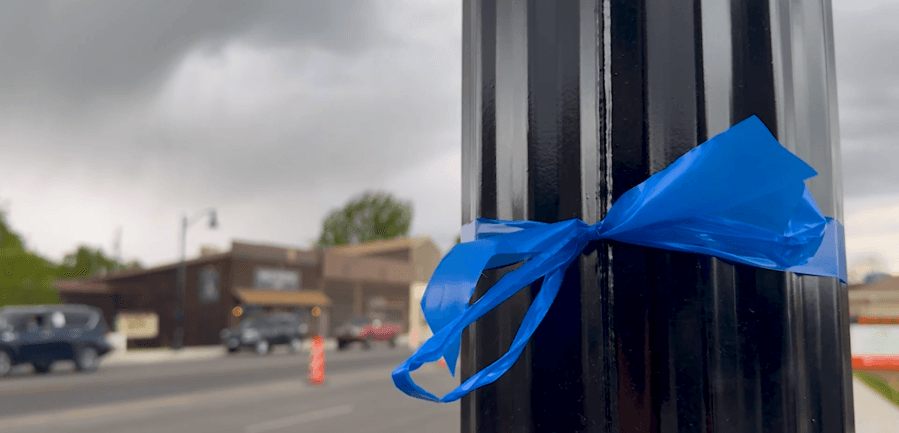 Family of fallen Santaquin officer line Main Street with blue ribbons, honoring his legacy