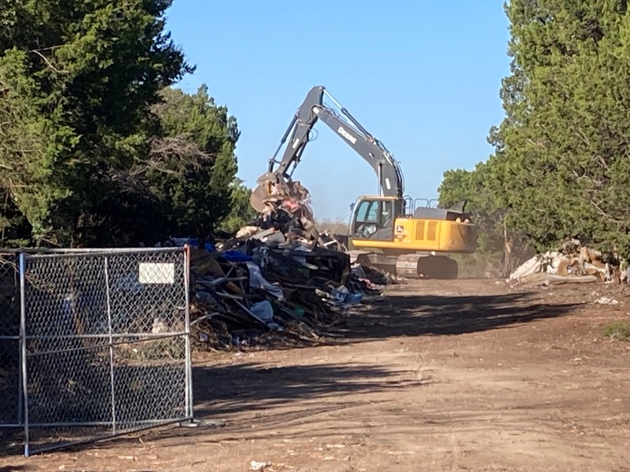 How does the city of Austin decide which homeless encampments to clear?