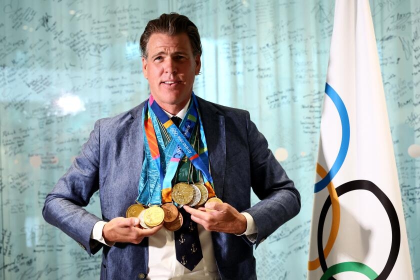 Gary Hall Jr. receives new Olympic medals to replace the 10 he lost in Palisades fire
