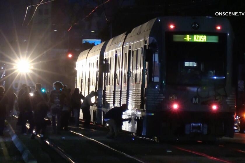 Mob wreaks havoc in downtown L.A., tagging buildings and trains as someone breathes fire