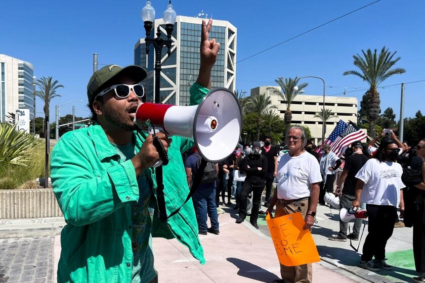Protesters gather at Santa Ana federal building: 'This is the healthiest thing to do'