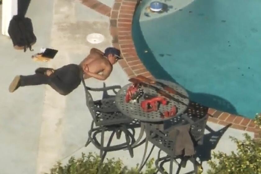 Man suspected of pointing shotgun at LAPD helicopter found lying by Chatsworth home pool