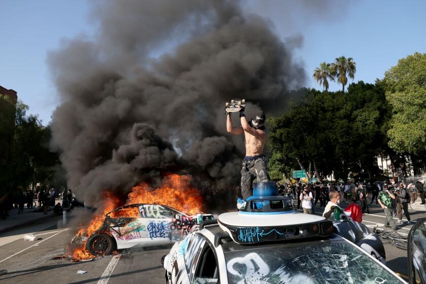 Waymo vehicles set on fire in downtown L.A, as protesters, police clash