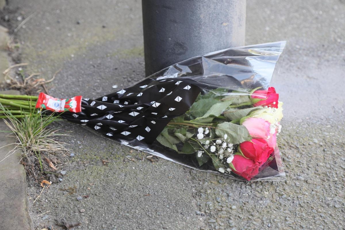 Tributes left as five teenagers arrested following death of pedestrian