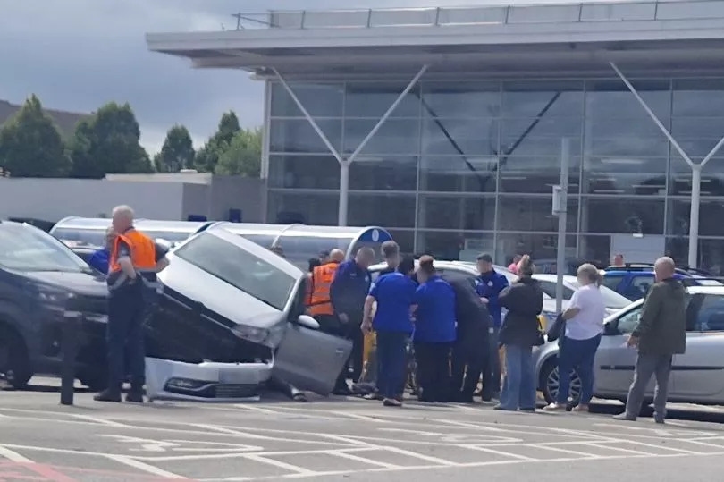 People 'rushed to help' after car 'reversed into bollard and mounted cars behind'
