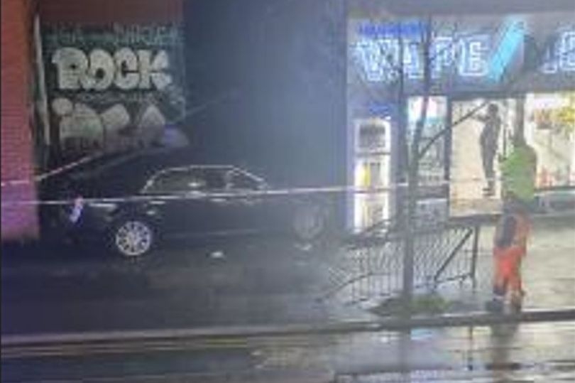Man rushed to hospital after car ploughs into Manchester shop