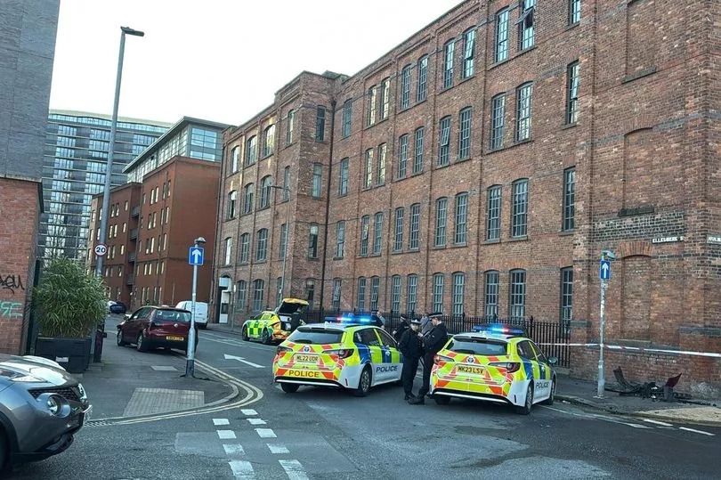 Area taped off and debris strewn over road after car crash near city centre
