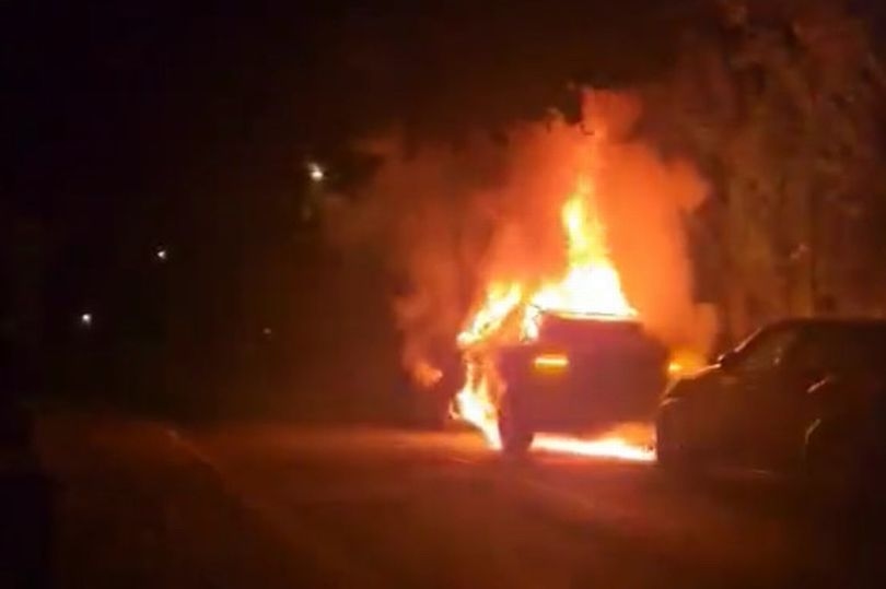 Emergency services flood street after car engulfed by flames