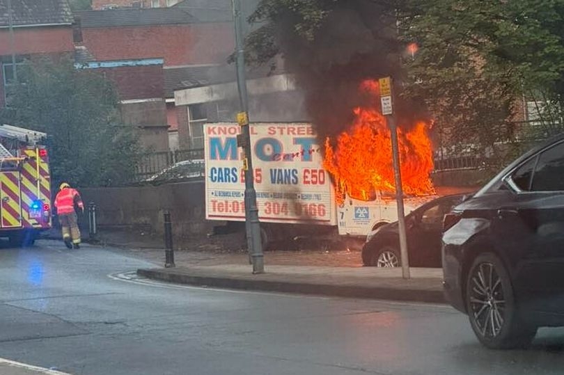 Dramatic pictures of advert van erupting into flames in street as fire crews tape off area