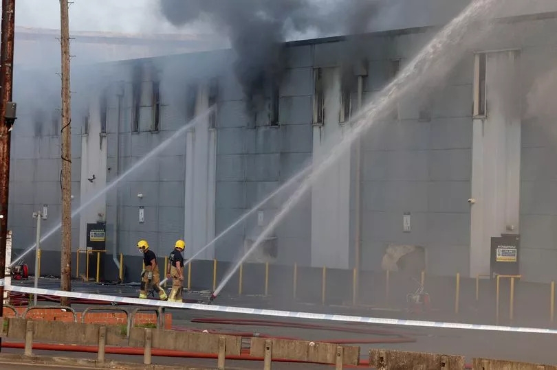 Roof of Middleton storage unit COLLAPSES as major fire burns for second day