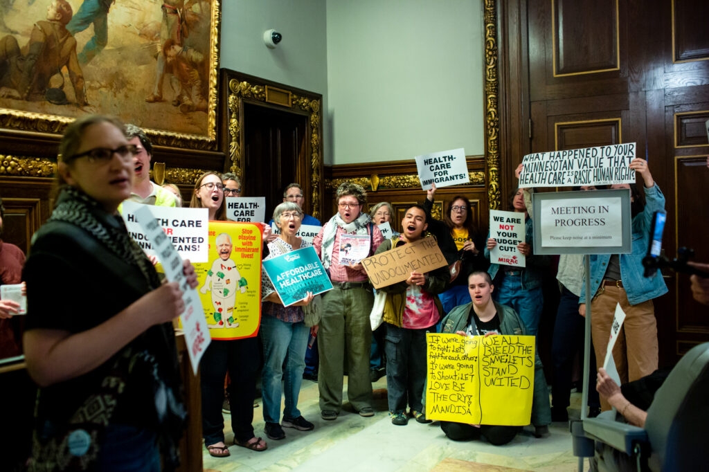 Immigrant rights activists protest plan to end low-cost health insurance for undocumented adults