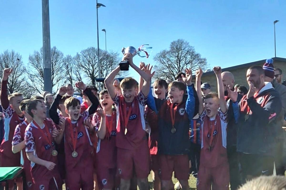 Football team celebrate their first silverware success