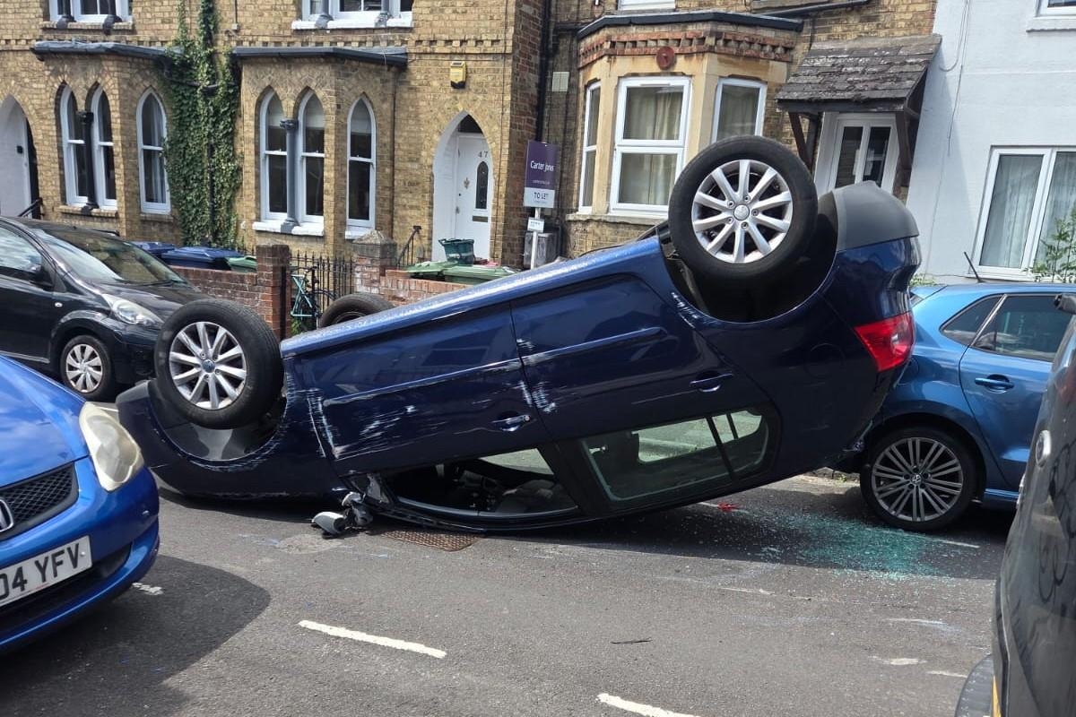 Police shut road in Iffley after car TURNS upside down
