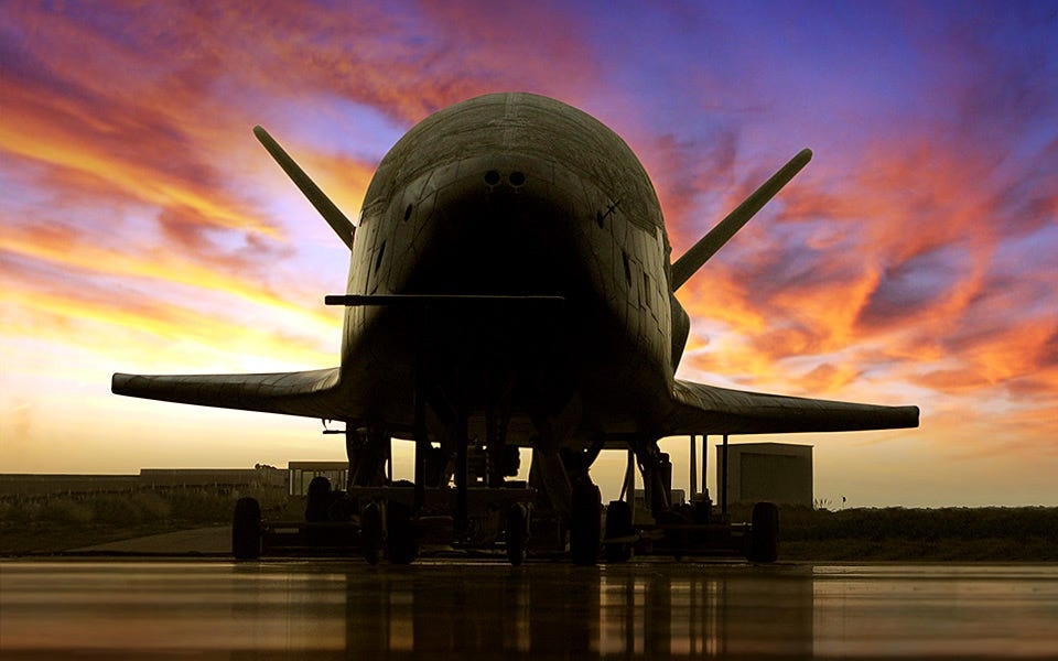 X-37B is a secret military space plane. Pictures show what it looks like before, after launch