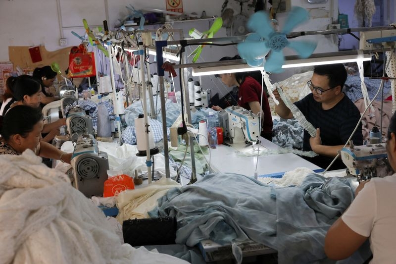 China's factory output resists tariff impact, retail sales disappoint