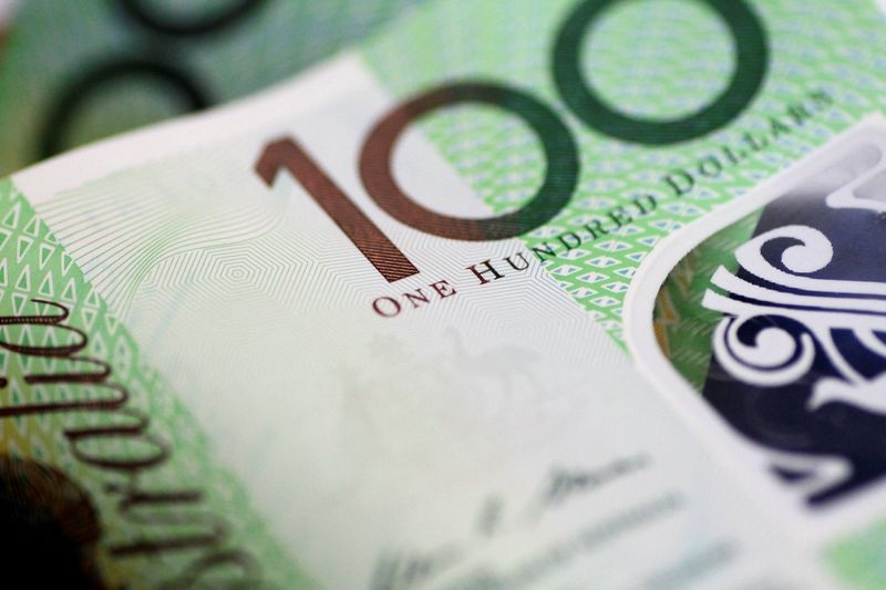 Australia dollar slips as RBA cuts rates, warns on global outlook