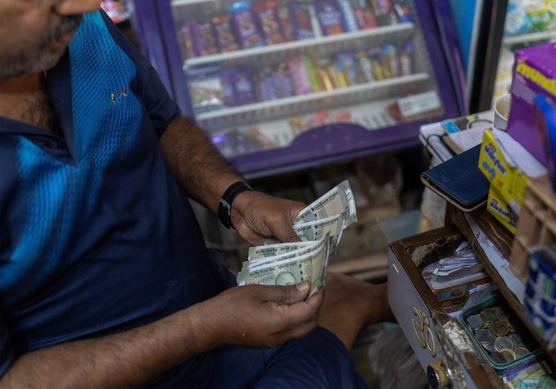 Rupee's upside capped by dollar bids from foreign and state-run banks