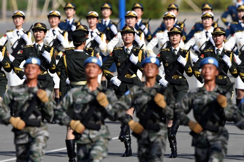 Taiwan says it is determined to defend itself as China vows to boost combat readiness
