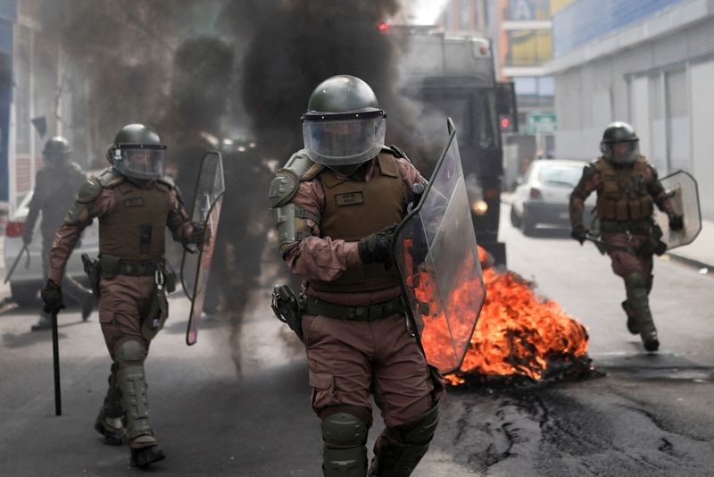 Protesters clash with police outside of Chile's Congress after fishing law vote gets delayed