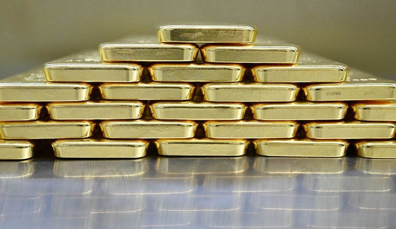 Gold hovers near two-week high on dollar weakness, US fiscal woes