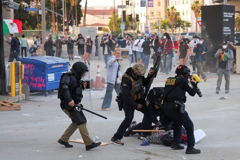 Riot police, anti-ICE protesters square off in Los Angeles after raids