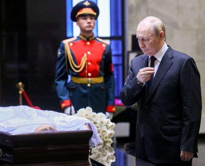 Russia's Putin joins mourners to pay respects to ex-classmate and top judge