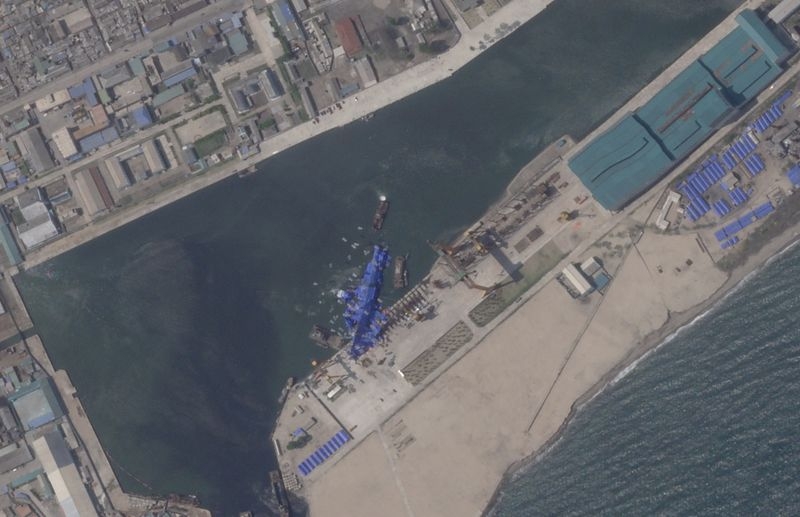 North Korea pulls capsized warship upright after botched launch, report says