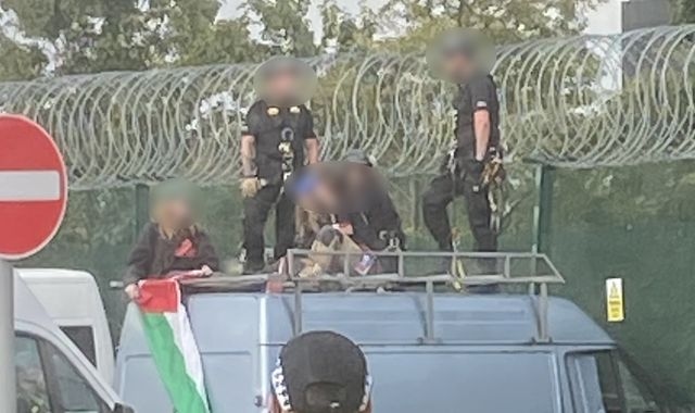 Three women charged under Terrorism Act after van driven into fence of defence factory