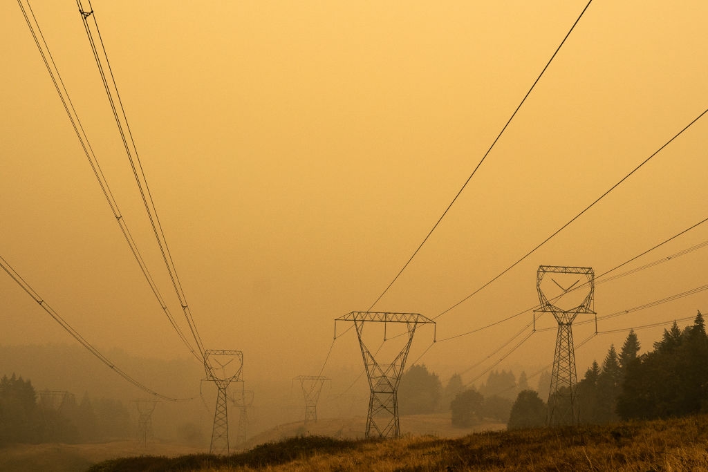 As wildfires intensify, utilities want liability protections. But then who pays?