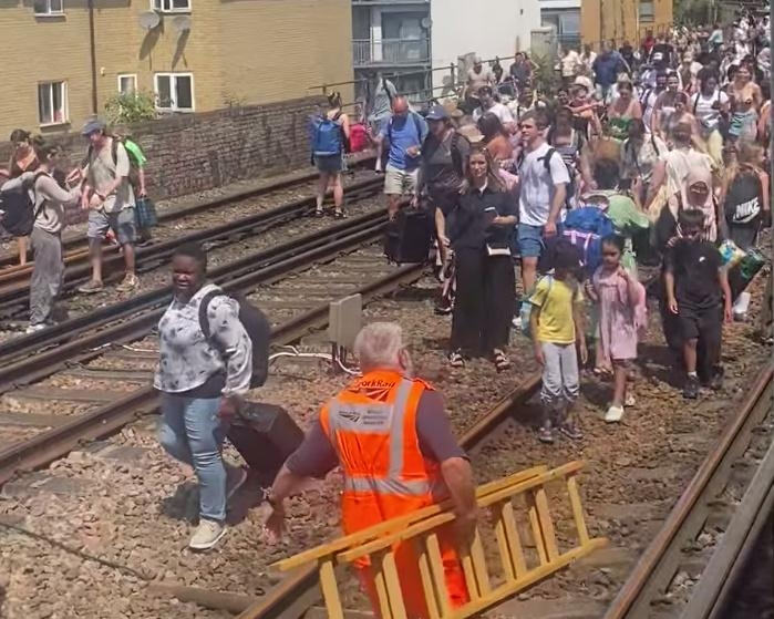 Evacuated London train passengers forced to walk along tracks on hottest day of year