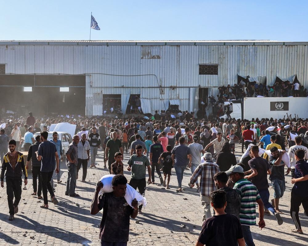 Four people killed after starving Palestinians burst into UN food warehouse in Gaza
