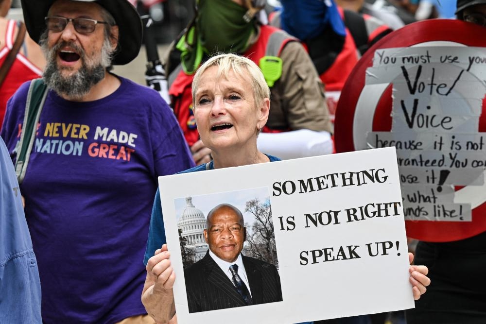 Tens of thousands in US join ‘Good Trouble' anti-Trump protests honoring John Lewis