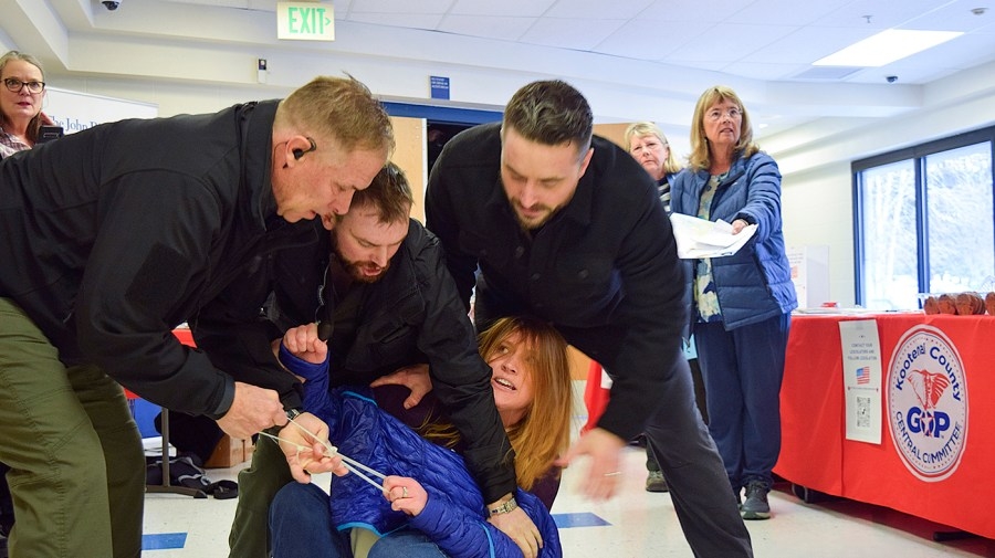 Woman dragged out of Republican town hall suing for $5M