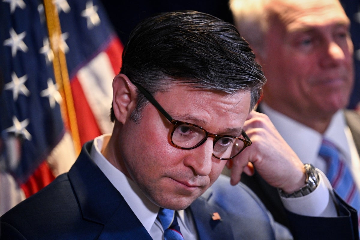 Mike Johnson caught looking at headlines about tanking economy as Trump boasts about his achievements on stage