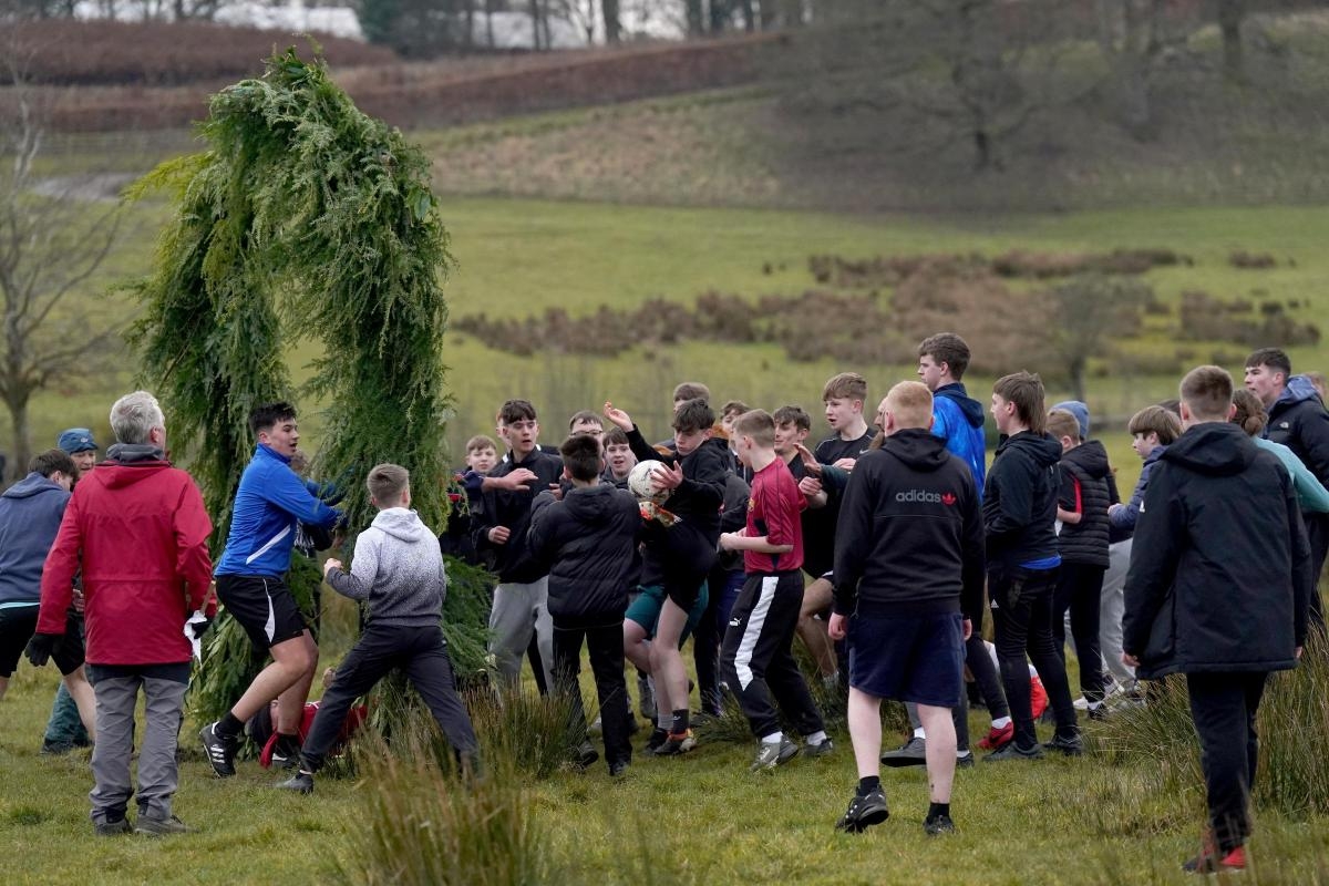 Photos as mad Shrove Tuesday football match ends in players jumping into river