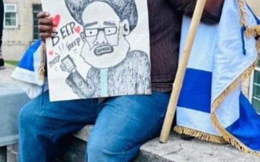 Jewish protester charged over placard mocking terrorist leader