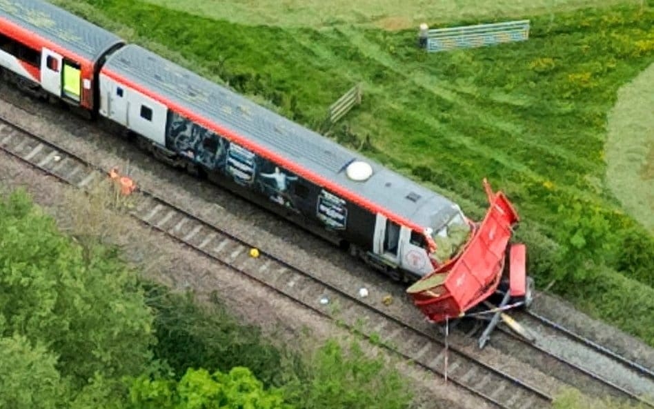 Man arrested after train crashes into farm trailer at level crossing