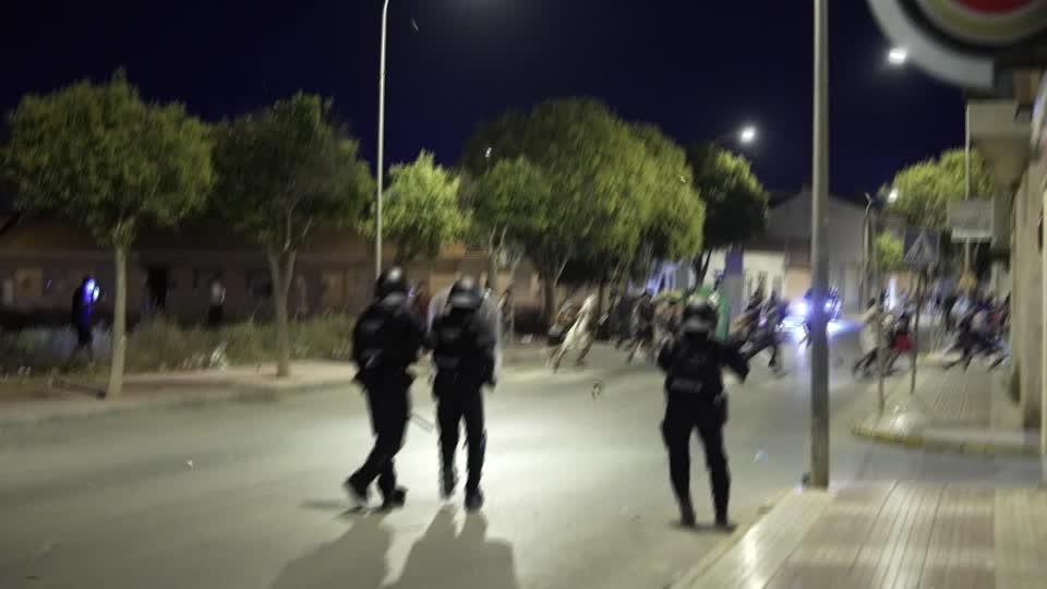 Anti-migrant groups clash with riot police in southeastern Spain