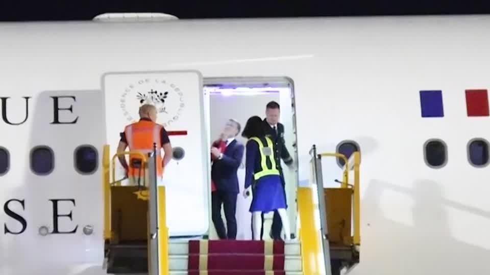 Macron's face appears to be shoved by wife in Vietnam