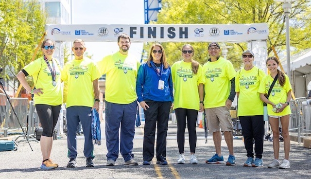 Knoxville marathon finish line captain inspiring students to run