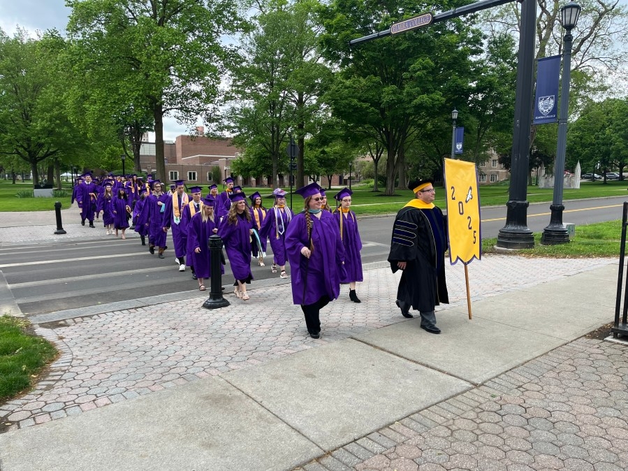 Graduates walk in Elmira College's 167th Commencement Ceremony
