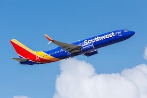 Local woman accused of trying to open airplane door mid-flight