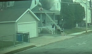 Teen rescues family from roof of burning home