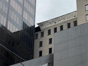 Facade of downtown high-rise building crumbling, fire department investigating