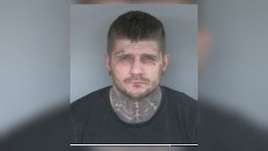 Man accused of jumping over fence while running from officers in custody
