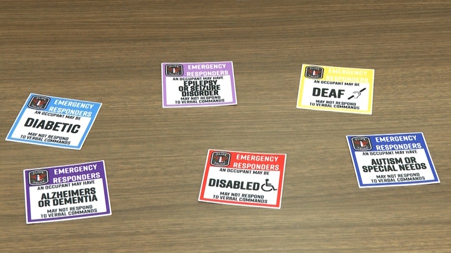 Clive police hand out awareness stickers to help communication in emergencies