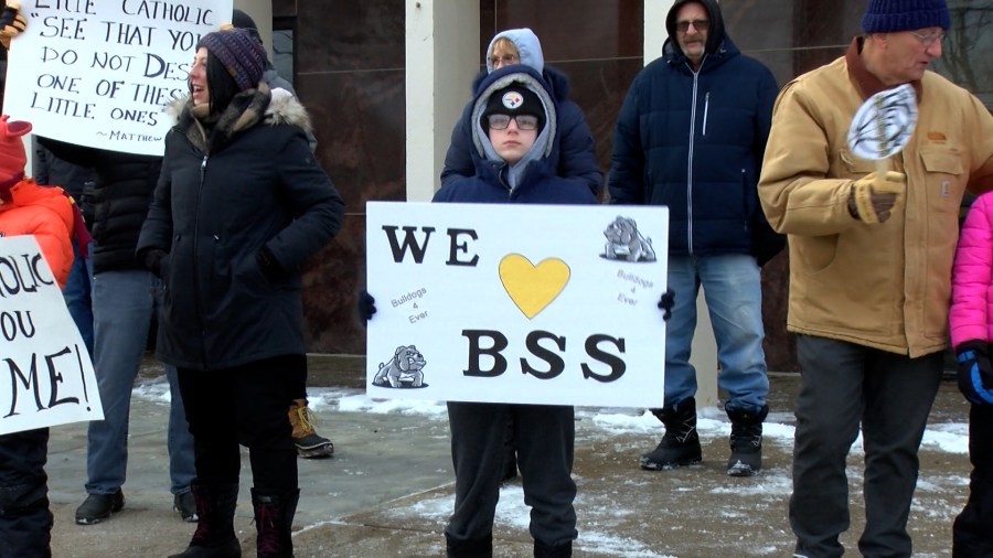 Dozens gather outside Blessed Sacrament School to protest closure