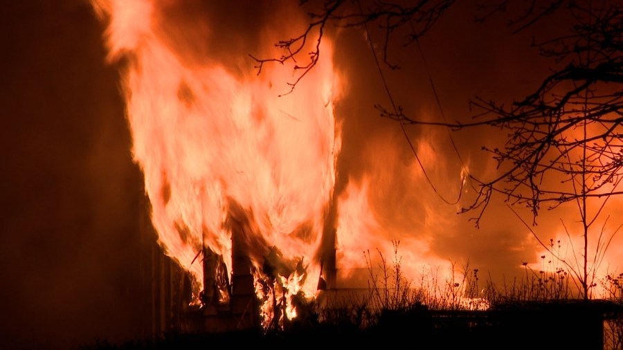 Barricaded suspect runs from home as it goes up in flames